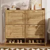 A wooden shoe cabinet with slatted doors and a metal frame, displaying shoes on the bottom shelf. Anteprima dell’immagine prodotto