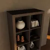 A close-up view of a wooden bookshelf with various decorative items and books. Produktbild-Vorschau