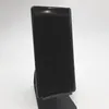 A black smartphone is displayed on a black stand against a white background. Podgląd zdjęcia produktu