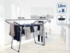 A drying rack with clothes hanging on it, set in a room with a painting on the wall. Produktbild-Vorschau