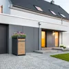 A modern house exterior with a trash can and planter box in front of the entrance. Produktbild-Vorschau