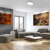 A modern living room with a sectional sofa, ottoman, coffee table, and abstract art on the walls. Podgląd zdjęcia produktu