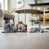 A LEGO Star Wars set is displayed on a wooden floor, with furniture in the background. Produktbild-Vorschau