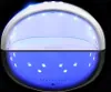 A white UV lamp for nail curing, with its reflection visible below, set against a black background. Produktbild-Vorschau