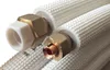 Close-up of insulated copper pipes with brass fittings. Produktbild-Vorschau