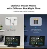 A split image showing two power modes for a weather station: DC power with always-on backlight and battery power with a 15-second backlight. The weather station is displayed on a desk with office supplies and a clock in the background. Náhled obrázku produktu