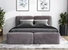 A modern bedroom setting with a large upholstered bed.