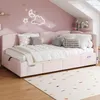 A child's bedroom with a pink upholstered bed and decorative elements. Anteprima dell’immagine prodotto