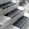 Several black rubber stair mats are placed on granite steps. Anteprima dell’immagine prodotto