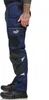 A person wearing navy blue Puma workwear trousers with black accents and shoes, shown from the side. Produktbild-Vorschau