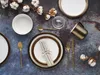 A table setting with plates, cutlery, a mug, and cotton branches. Náhľad obrázku produktu