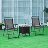 Two folding chairs and a small table are set up on a green lawn in front of a large window with sheer curtains. Produktbild-Vorschau