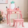 A pink children's vanity table and stool set with a strawberry-shaped mirror and accessories. Produktbild-Vorschau