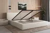 A bedroom scene featuring an open storage bed with a slatted base, a bedside table, and wall art. Produktbild-Vorschau
