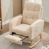 A beige teddy velvet rocking chair with a reclined footrest is shown in a room. Voir les images du produit
