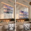 A split image showing a TV wall mount in two different positions, with a fireplace and seating area in the background. Produktbild-Vorschau