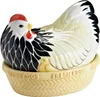 A ceramic chicken-shaped egg holder with a chick peeking out from under its wing, sitting in a basket labeled 'FRESH EGGS'. Náhled obrázku produktu