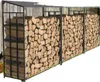 A long, multi-sectioned firewood rack filled with chopped wood, set against a wooden fence. Podgląd zdjęcia produktu