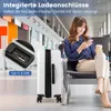 A woman sits in an airport lounge, using her phone while a white suitcase with integrated charging ports is beside her. Náhled obrázku produktu