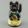 A black Maneki-neko (lucky cat) figurine sits on a pile of gold coins. Produktbild-Vorschau