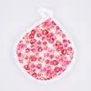 A pink floral pot holder on a white background. Produktbild-Vorschau