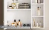 Interior view of a white bathroom cabinet with various toiletries and accessories displayed on shelves. Voir les images du produit