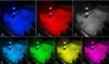 Multiple images showing car interior floor mats illuminated by RGB lights in different colors. Produktbild-Vorschau
