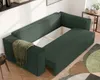 A modern green sofa with storage is shown in a well-lit room with a rug and wooden floor. Voir les images du produit