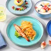 A table setting with plates of food and a drink. Produktbild-Vorschau