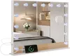 A vanity mirror with LED lights is placed on a shelf above a bed, with a phone charging on the shelf. Produktbild-Vorschau