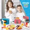Two children are playing with a toy kitchen set, which includes a microwave, toaster, and mixer, along with various food items. Produktbild-Vorschau