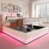 A modern upholstered bed with its storage compartment open, revealing stored items. The bed features LED lighting around its base. Náhľad obrázku produktu