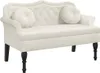 A cream-colored velvet loveseat with tufted backrest and two round throw pillows, set against a white background. Produktbild-Vorschau
