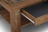 A close-up view of a wooden coffee table with a drawer partially open, revealing a dark interior and a white drawer slide. Náhled obrázku produktu