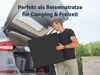 A man is loading a folded mattress into the trunk of a car. Produktbild-Vorschau