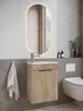A modern bathroom vanity with a sink and cabinet, illuminated mirror, and a toilet. Anteprima dell’immagine prodotto
