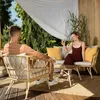 A couple relaxing on a patio set with drinks. Náhľad obrázku produktu