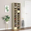 A tall, narrow shoe cabinet filled with shoes, placed next to a white door and a plant. Produktbild-Vorschau