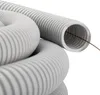 A close-up, studio shot of coiled gray corrugated tubing. Produktbild-Vorschau