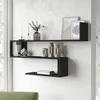 A modern living room with black wall shelves displaying decorative items and books. Náhled obrázku produktu