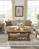 A living room scene with a couch, coffee table, and rug. Produktbild-Vorschau
