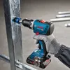 A person wearing a glove is using a Bosch cordless drill to make a hole in a metal stud. Náhled obrázku produktu