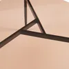 A close-up view of the metal frame and glass top of a round coffee table. Voir les images du produit
