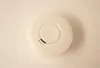 A smoke detector is shown from a top-down view against a plain white background. Produktbild-Vorschau