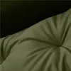 A close-up view of a tufted green cushion, possibly a pet bed, with a dark background. Podgląd zdjęcia produktu
