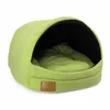 A green dog bed with a hooded opening. Náhľad obrázku produktu