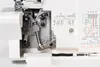Close-up view of the internal mechanism and threading guides of a white sewing machine. Produktbild-Vorschau
