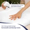 A hand is pressing into a white pillow, demonstrating its softness and shape retention. A close-up inset shows a zipper on a pillowcase. Produktbild-Vorschau
