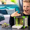 A young boy is playing with a Schleich Eldrador Creatures BattleCave Steinchamäleons toy set. Produktbild-Vorschau