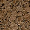 A close-up, overhead view of many small, round, brown chocolate pieces. Produktbild-Vorschau
